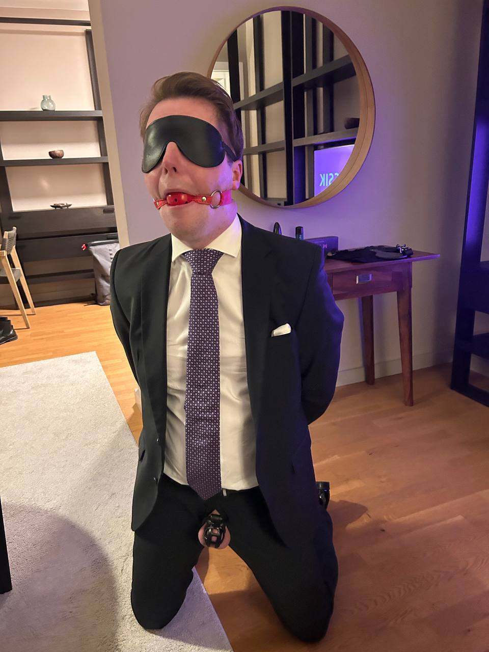 Gagged suited sub