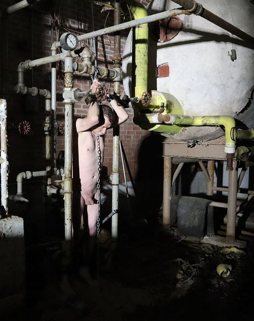 Nude slave in freezing basement