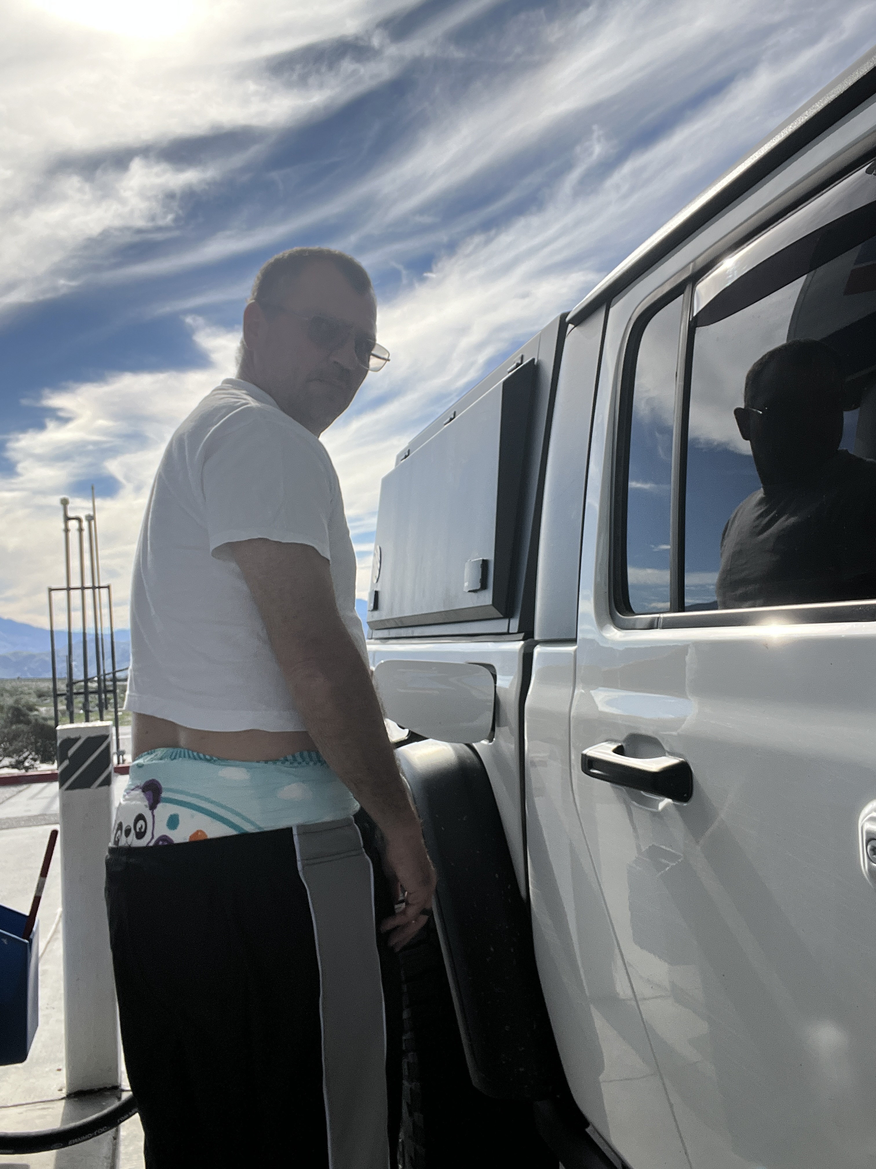 Diaper boy pumping gas